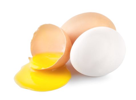 Broken eggs with a yellow yolk isolated on white background