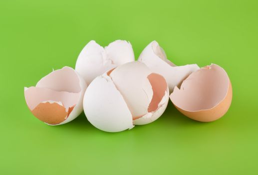 Group pieces of egg shell on a green background