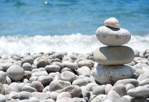 Stack sea pebbles against the blue sea