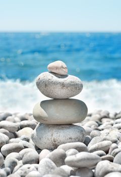 Stack sea pebbles against the blue sea