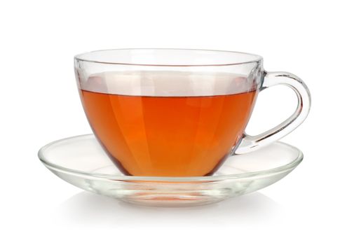 Glass cup of tea and saucer isolated on white background