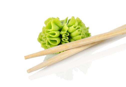 Wooden chopsticks and wasabi isolated on a white background