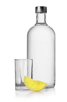 Bottle of vodka and lemon isolated on a white background