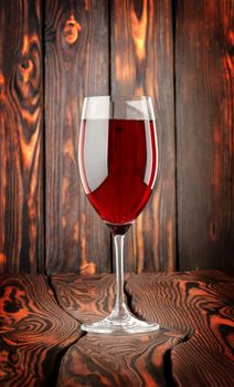 Glass of red wine on a wooden background