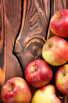 Red apples on a wooden background