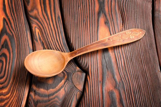 Wooden spoon on the old wooden table