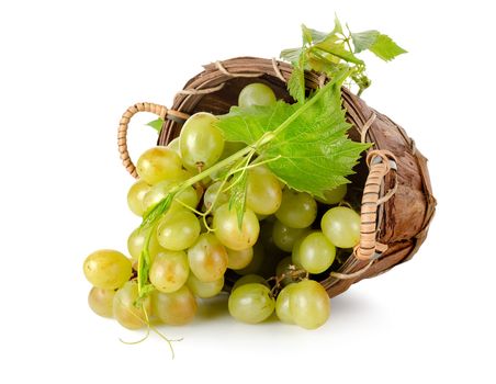 Grapes in a wooden basket isolated on white background