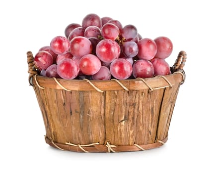 Dark blue grapes in a wooden basket isolated on white background