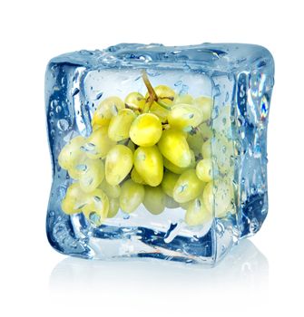 Ice cube and green grapes isolated on a white background