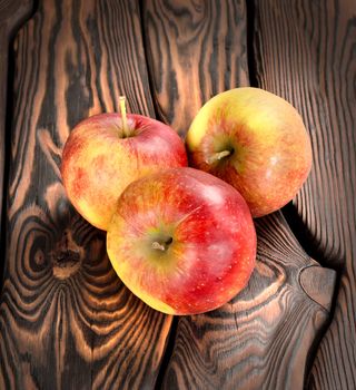 Red apples on a wooden background