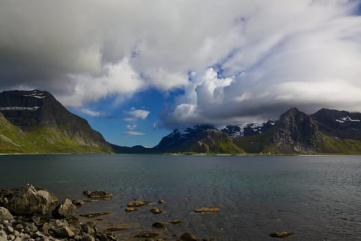 Picturesque cloudy mountain peaks on Lofoten islands in Norway