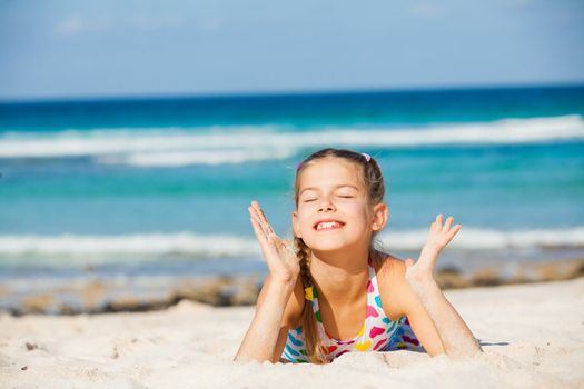 Adorable beautiful girl having fun on the tropical beach.
