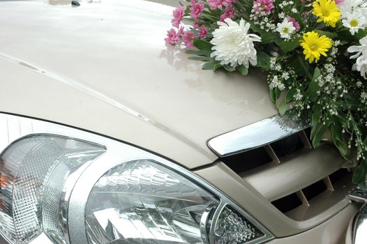 series of colorful fresh flowers on the wedding car