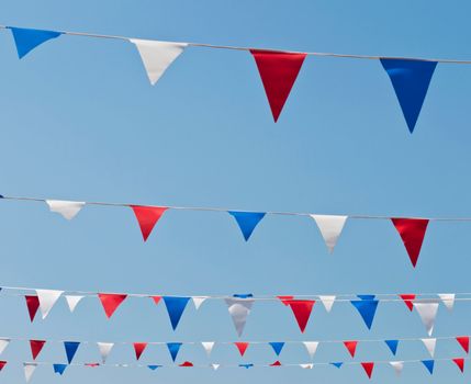 colorful festive bunting flags against a blue sky background (United Kingdom)
