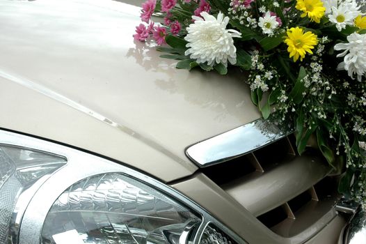 series of colorful fresh flowers on the wedding car