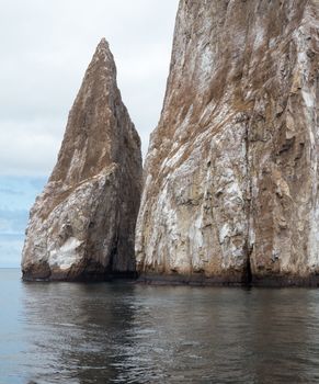Sleeping Lion or Leon Dormida rock formation off coast of Galapagos islands