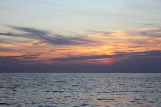 Sun down in the calm sea.