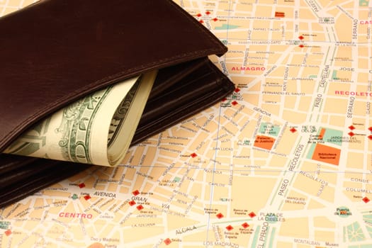 Wallet with banknotes on city map.