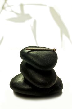 acupuncture needle on stone