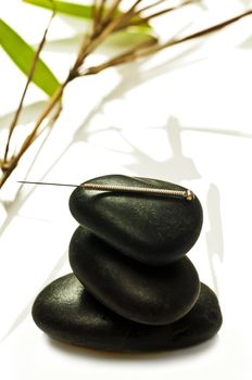 acupuncture needle on stone