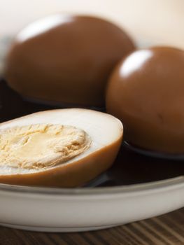 close up of a bowl of braised soy sauce eggs