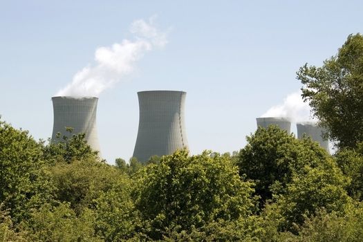 photograph of chimneys of a nuclear power plant in activity