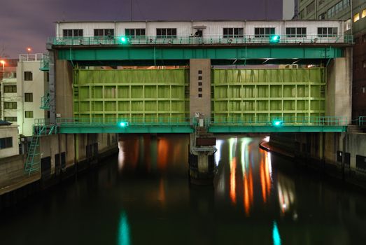 typical huge flood gate in Tokyo metropolis with scenic night illumination