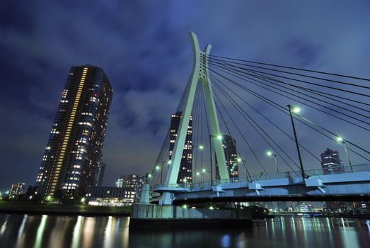 modern Chuo-Ohashi bridge in Tokyo over Sumida river waters by night