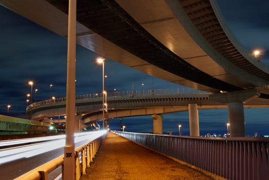 wideangle night image of well and high density organized Japanese urban roads with pedestrian pathway