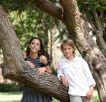 Happy young couple near the tree .