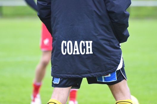 A football coach at a football field