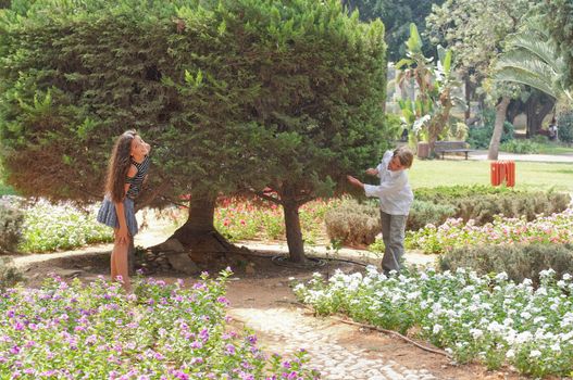 Happy young couple near the tree .