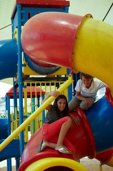 Happy young couple on the playground .