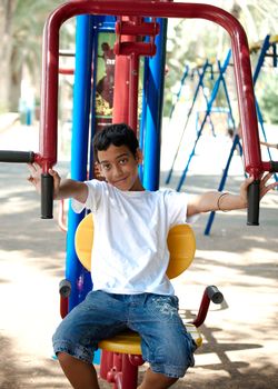 Boy on playground in summer day .