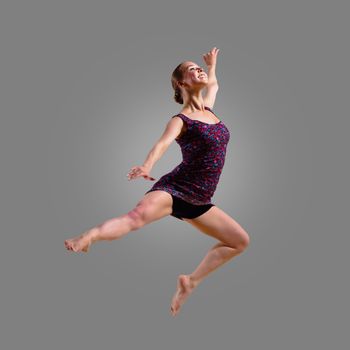 dancer jumping on a gray background, having a fun