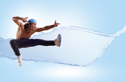 Dancer jumping on the background color splashes