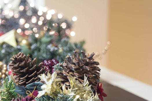 Christmas Decoration Garland with Poinsettia Pine Cones and Blurred Bokeh Lights Background