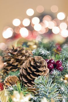 Christmas Decoration Garland with Poinsettia Pine Cones and Blurred Bokeh Lights Background Portrait