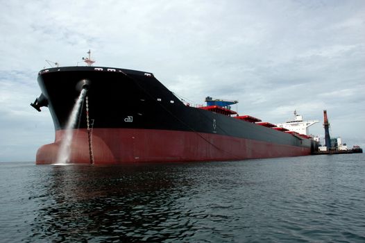 a large coal tanker, which was anchored in the middle of the ocean