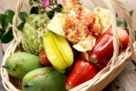 varieties of tropical fruits in bamboo basket