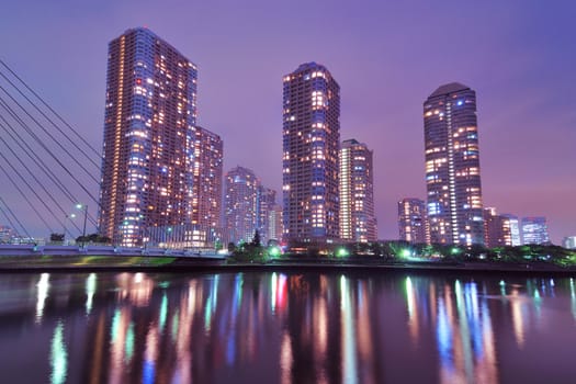 night skyscrapers cityscape in Tokyo metropolis over Sumida river waters