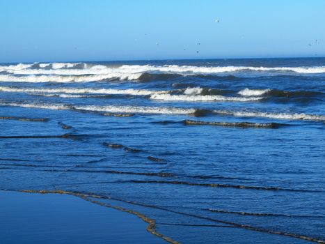 Ocean Waves Breaking on Shore on a Clear, Sunny Day