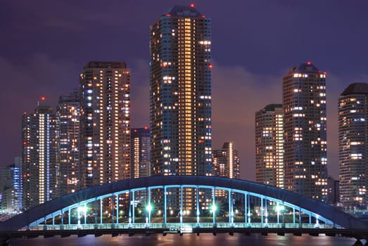 cityscape of night Tokyo Metropolis, modern skyscraper buildings at Tsukishima district and Eitai bridge