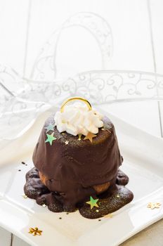 Christmas cupcake as a bell with decoration on white wooden table