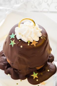 Christmas cupcake as a bell with decoration on white wooden table