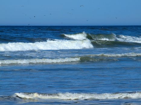 Ocean Waves Breaking on Shore on a Clear, Sunny Day