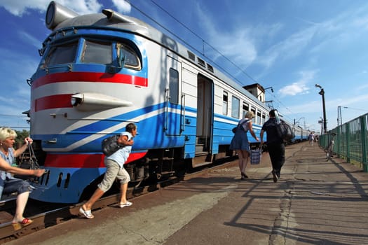 Passengers rush to land a suburban train