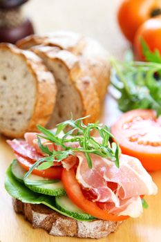 Ham with rocket and tomato sandwich