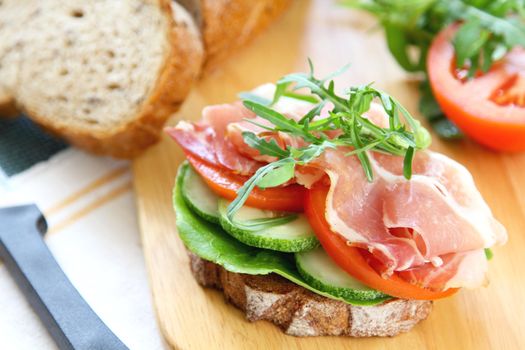 Ham with rocket and tomato sandwich