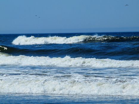 Ocean Waves Breaking on Shore on a Clear, Sunny Day